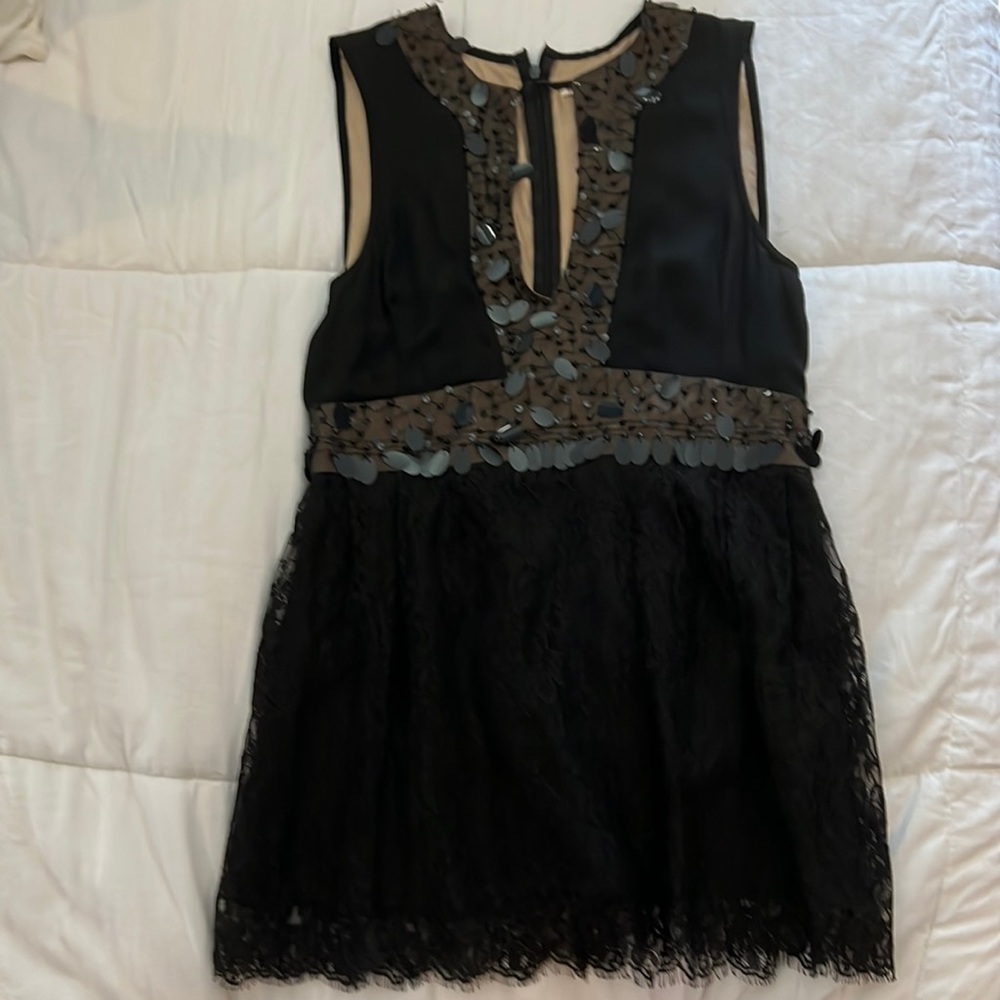 Beautiful black top with lace. Very detailed and define. Size 4 women’s.